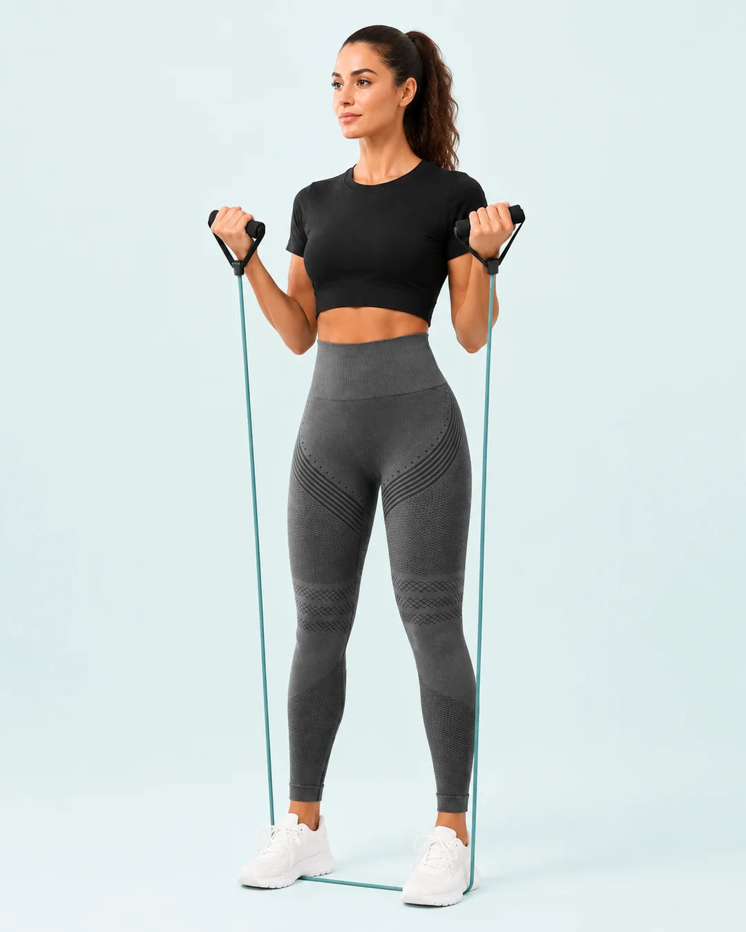 A woman wearing AvenLife leggings during a light resistance-band workout